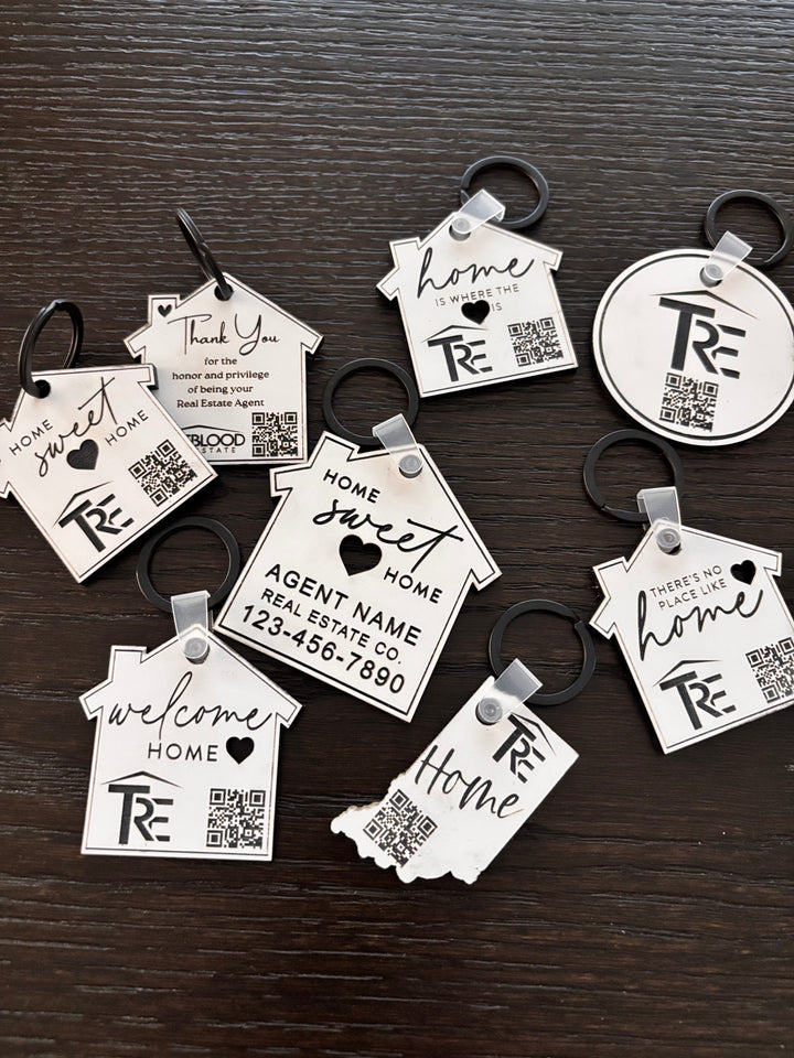 Custom branded house keychains with logo and QR code engraved on white acrylic for real estate closing gifts