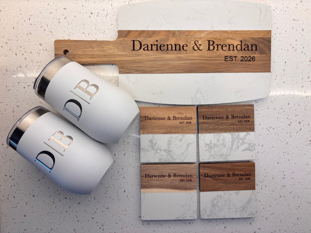 Custom engraved closing gift basket with marble and acacia charcuterie board, two personalized 16oz wine tumblers, and four engraved coasters in a decorative gift basket, perfect for housewarming, new homeowners, and real estate agent client gifts.
