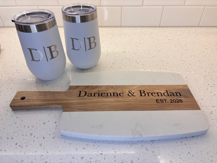 Custom engraved closing gift basket with marble and acacia charcuterie board, two personalized 16oz wine tumblers, and four engraved coasters in a decorative wire gift basket, perfect for housewarming, new homeowners, and real estate agent client gifts.