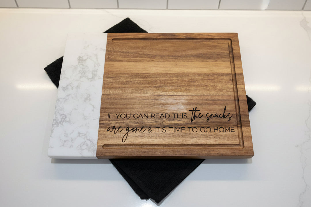 Close-up of personalized marble and wood cutting board with engraved logo for corporate and wedding gifts