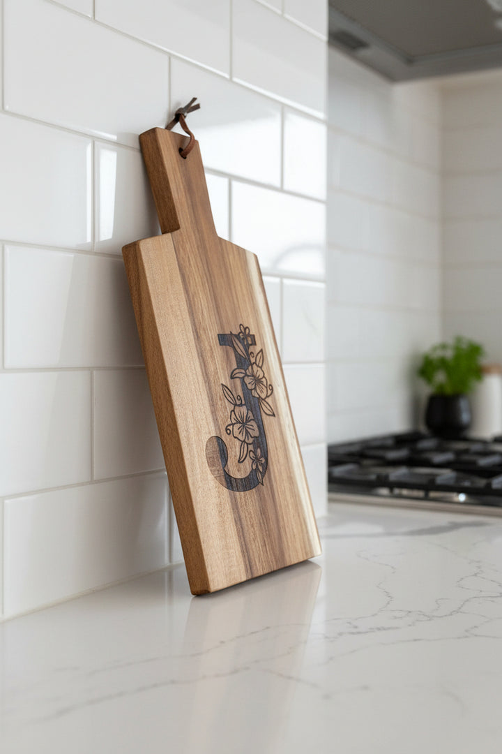 Custom engraved monogram acacia wood cutting board displayed in kitchen, personalized gift for Mother’s Day, birthdays, or housewarming.