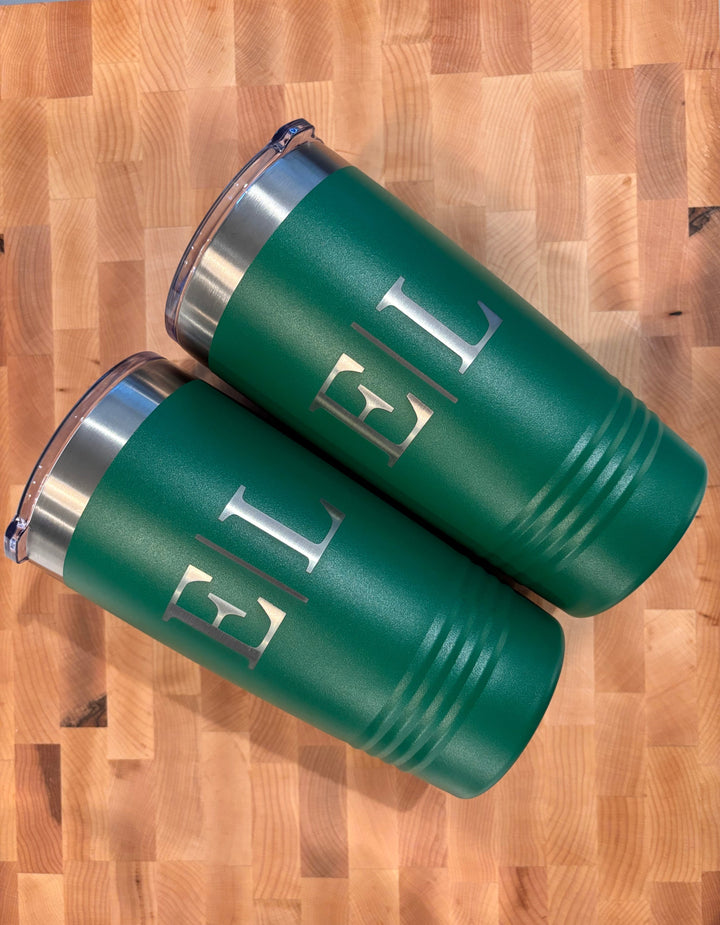 Green Polar Camel stainless steel tumblers with monogram engraving displayed on a wood cutting board surface for personalized drinkware gifts.