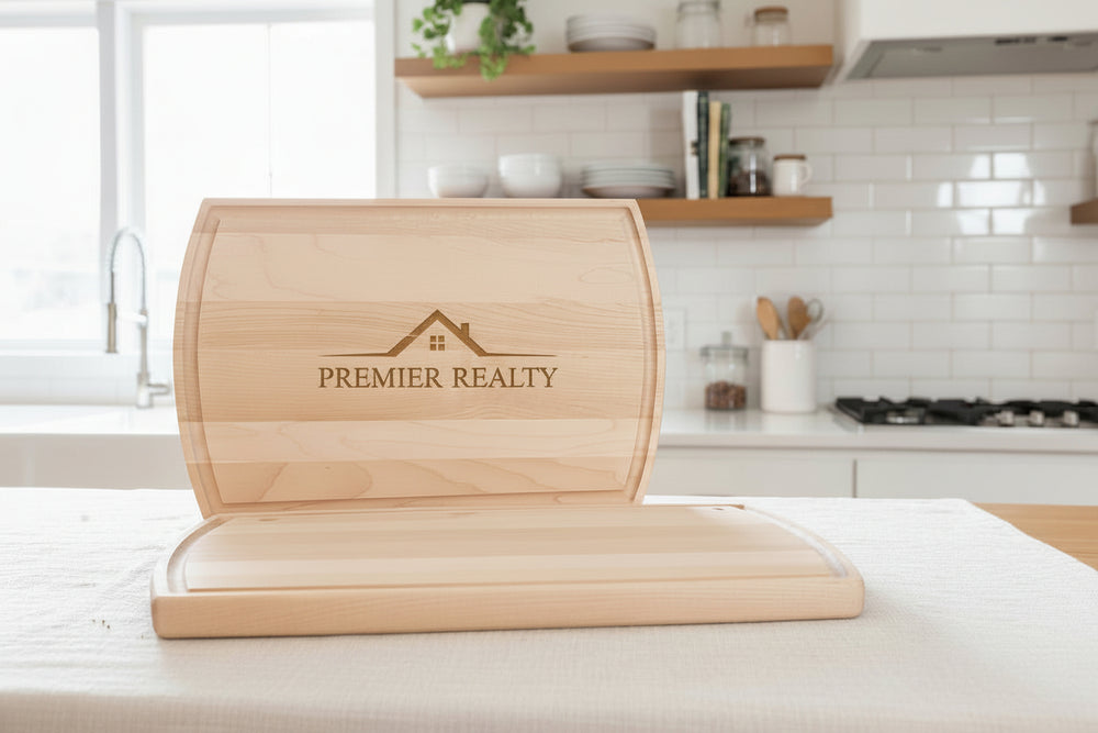 Front view of large arched maple cutting board with custom engraved logo and smooth finish