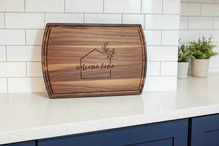 Front view of large arched walnut cutting board with custom engraved logo and smooth finish