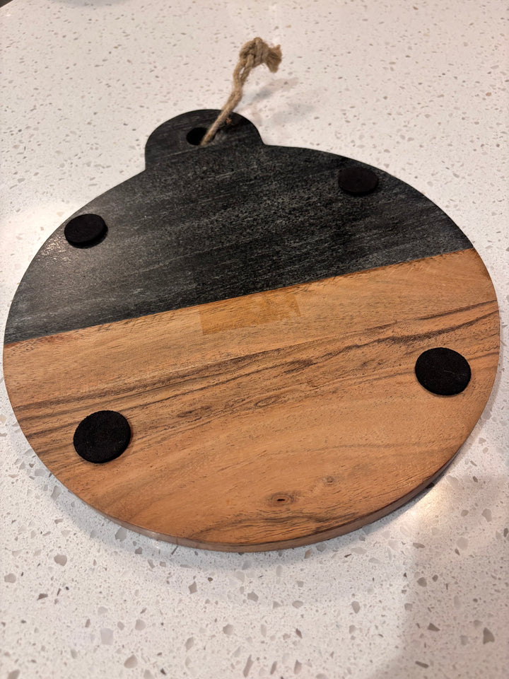 Back view of marble and wood round cutting board with non-slip feet and hanging rope, perfect for wedding or housewarming gift.