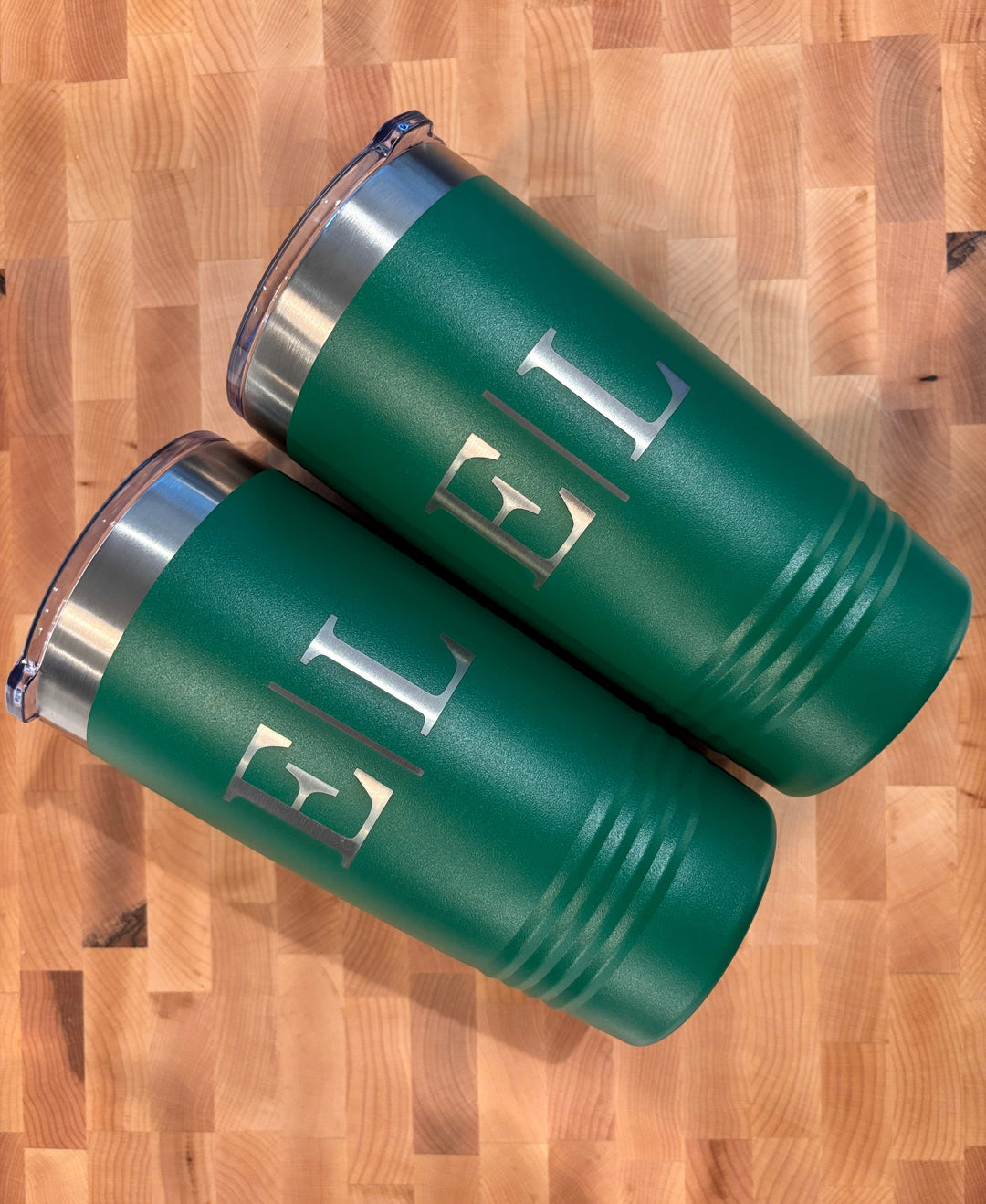 Personalized green stainless steel tumblers with monogram engraving included in marble and acacia charcuterie gift basket set.