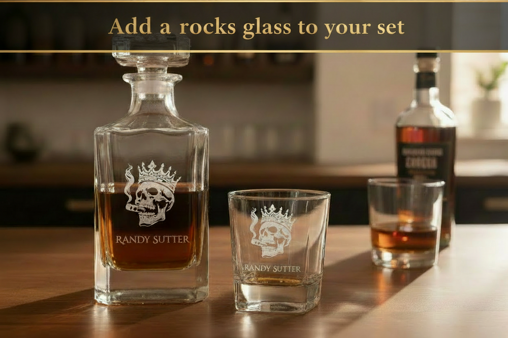 Engraved whiskey glasses for groomsmen gifts displayed in group on wood surface with whiskey bottle and bar tools
