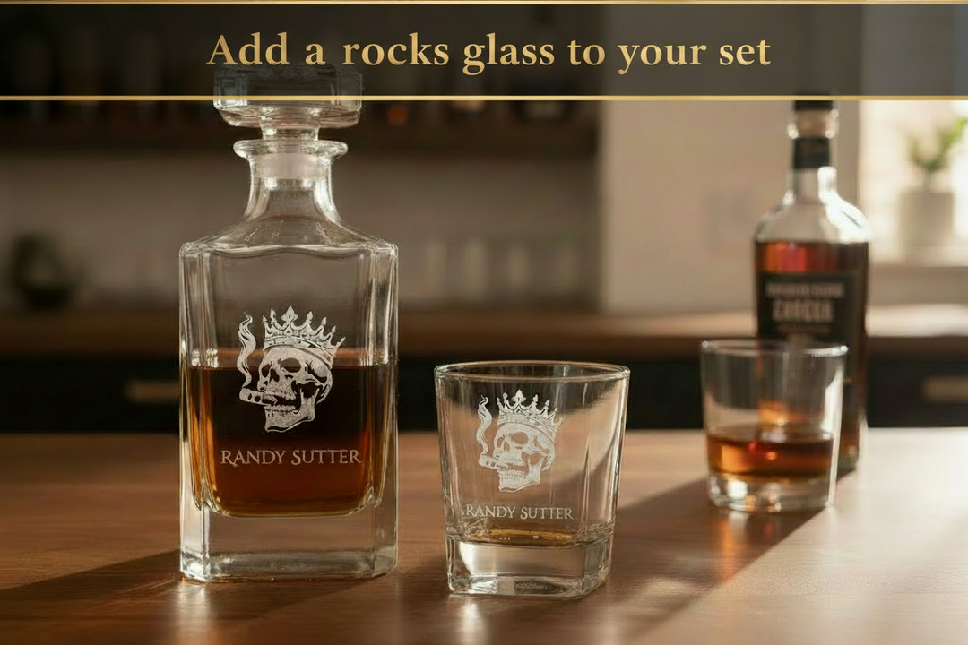 Engraved whiskey glasses for groomsmen gifts displayed in group on wood surface with whiskey bottle and bar tools