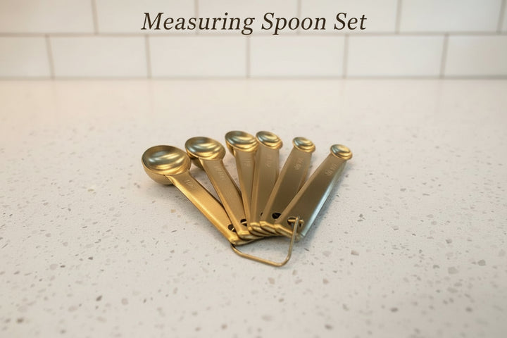 Gold measuring spoons included in personalized wood cutting board gift set for closing and housewarming gifts