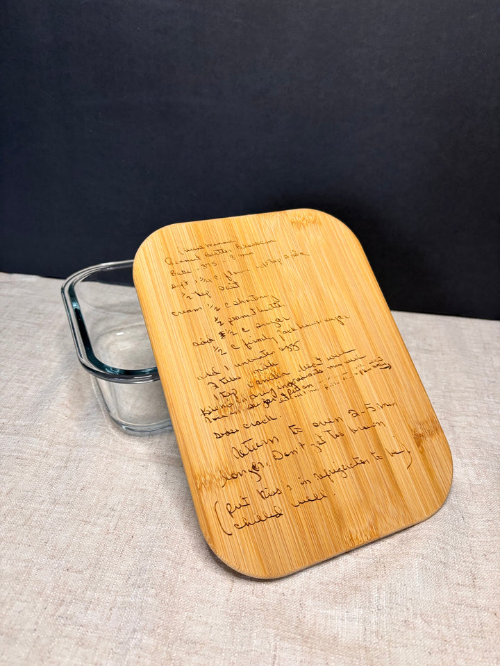 Video showing custom engraving of a recipe design on a glass food storage container with bamboo lid